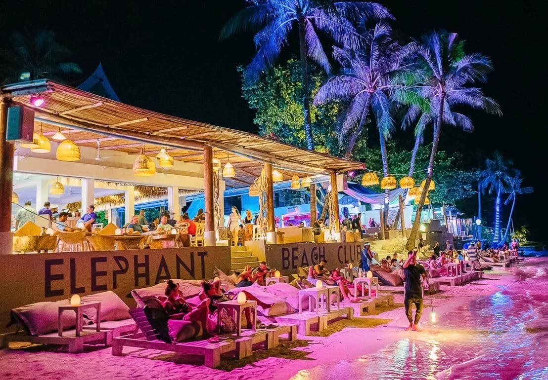Beachfront bar at sunset with warm atmospheric lighting: social life on Koh Samui