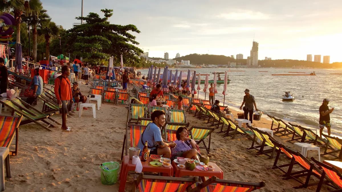 Person cycling along the seafront promenade: outdoor life in Pattaya