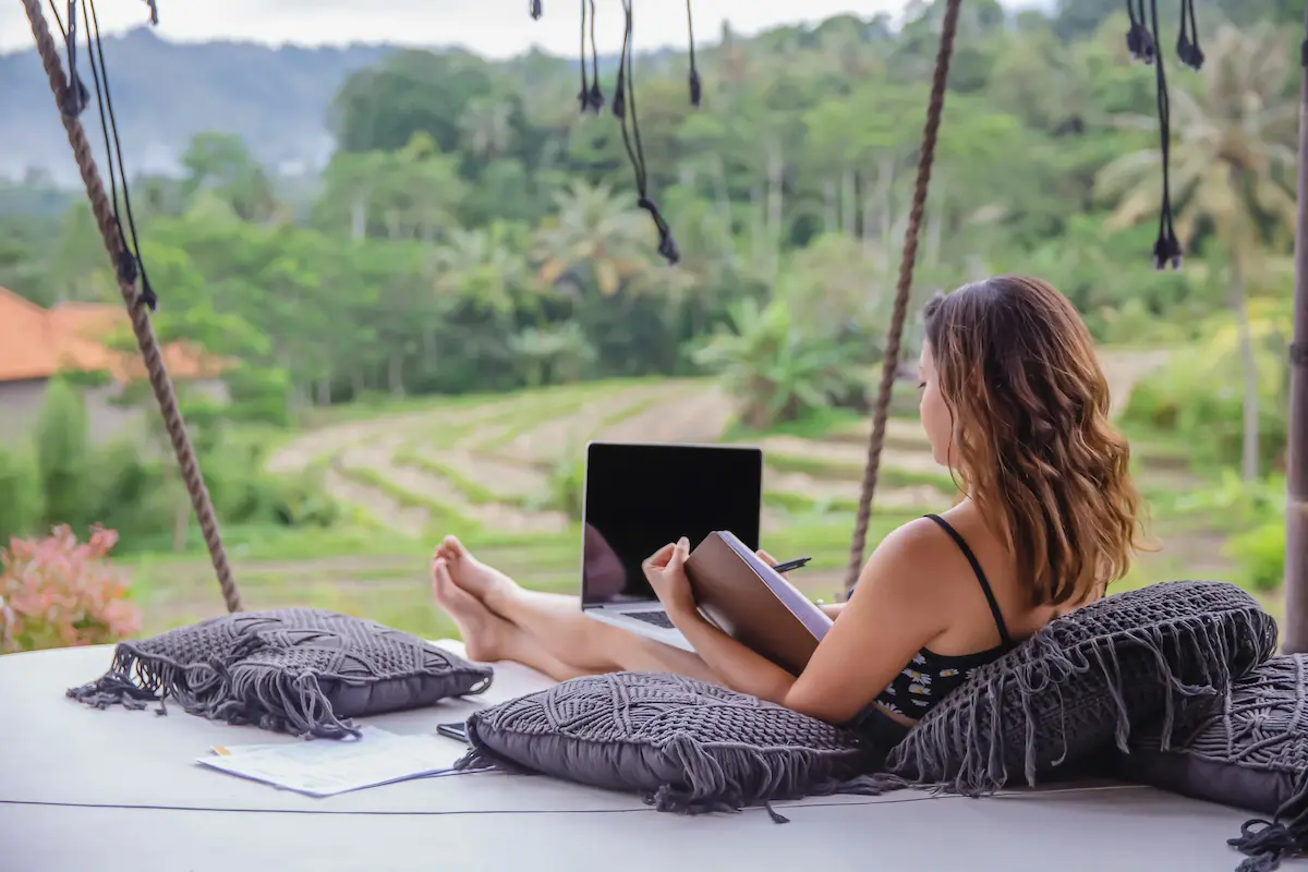 Person working on a laptop in a coastal city cafe: remote work in Pattaya