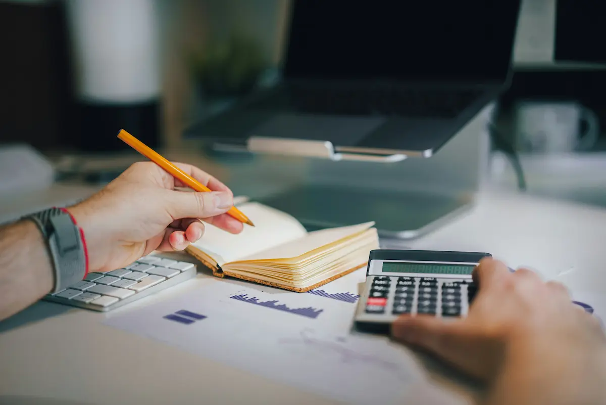Calculator and notebook on a desk